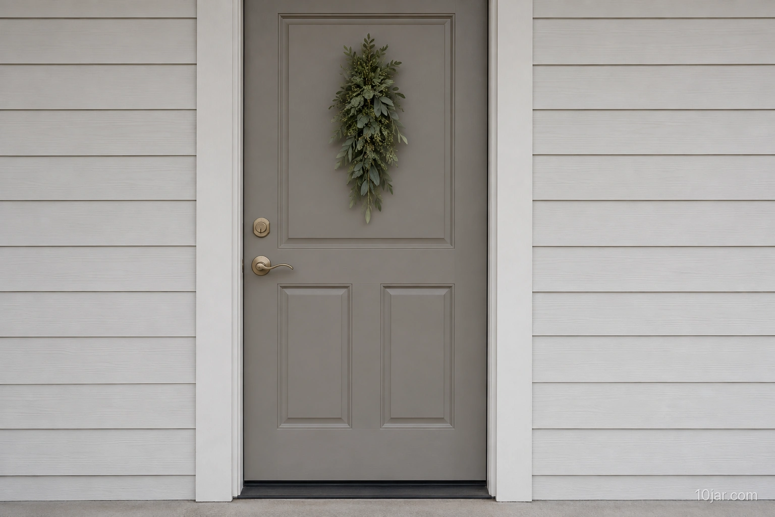 Warm gray exterior door with a narrow unlit olive-green foliage piece clear of handle, lock, and threshold