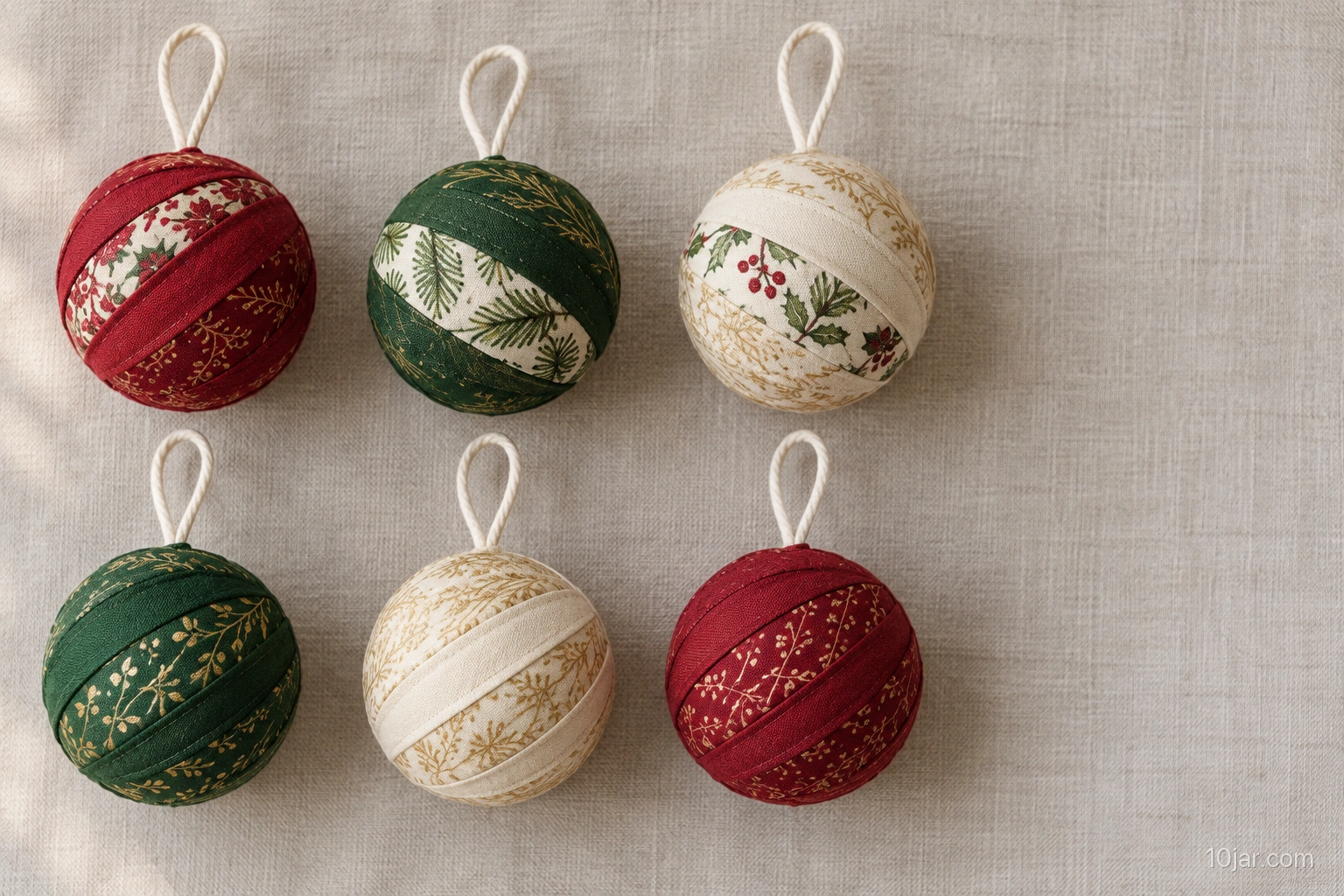 Exactly six three-inch fabric-scrap wrapped ornaments in red green and cream with secure simple loops and no loose trim